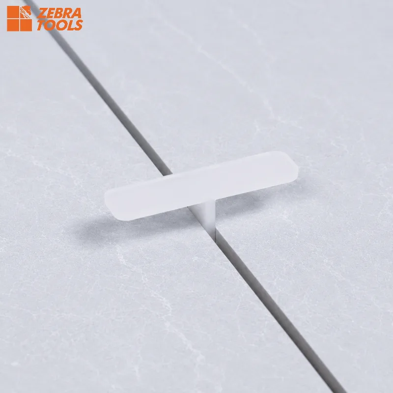 T-Shaped spacer profile close-up — extended leg holds tiles flat against the wall
